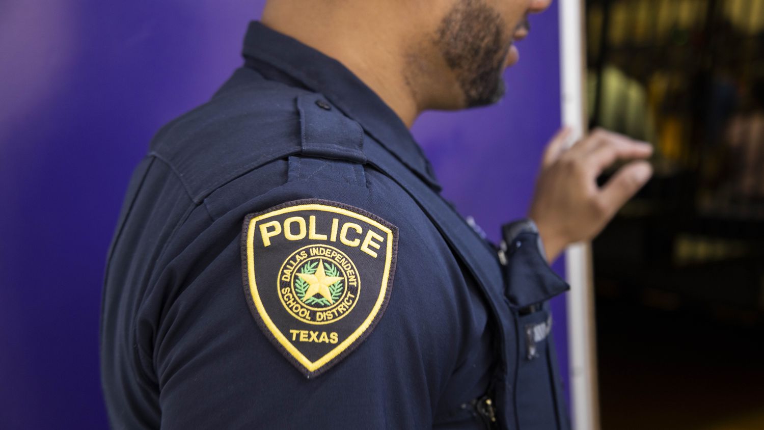 Dallas ISD officer Sam Walton stands at LincolnHigh School and Humanities/Communications...