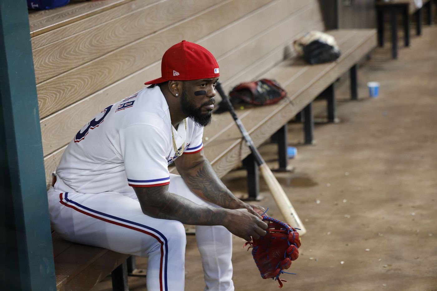 Texas Rangers right fielder Adolis Garcia (53) sit in the dugout before a baseball game...