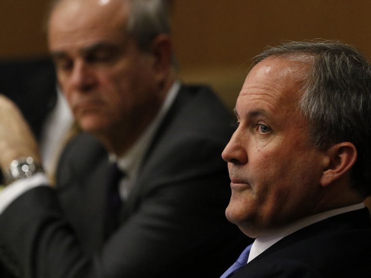 Texas Attorney General Ken Paxton, right, looks at one of the special prosecutors during a...