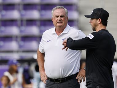 TCU head coach Sonny Dykes, left, is seen during a warming up session before an NCAA college...