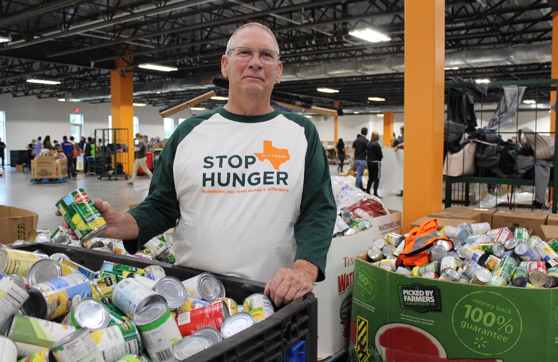 A North Texas Food Bank (NTFB) volunteer gathers food donations for distribution across...