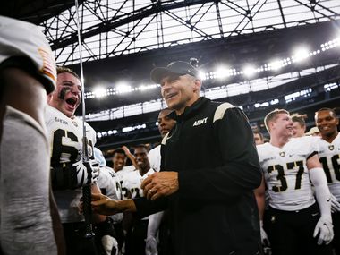 Army Black Knights head coach Jeff Monken celebrates with players after winning during...
