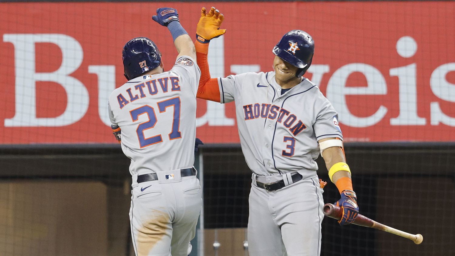 Houston Astros second baseman Jose Altuve (27) gets a high-five from his teammate shortstop...